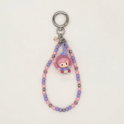 Keychain with pastel-colored beads and a small figurine on a light gray background