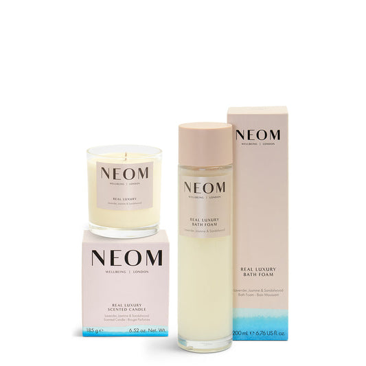 NEOM product set including a candle, bath foam, and box on a white background
