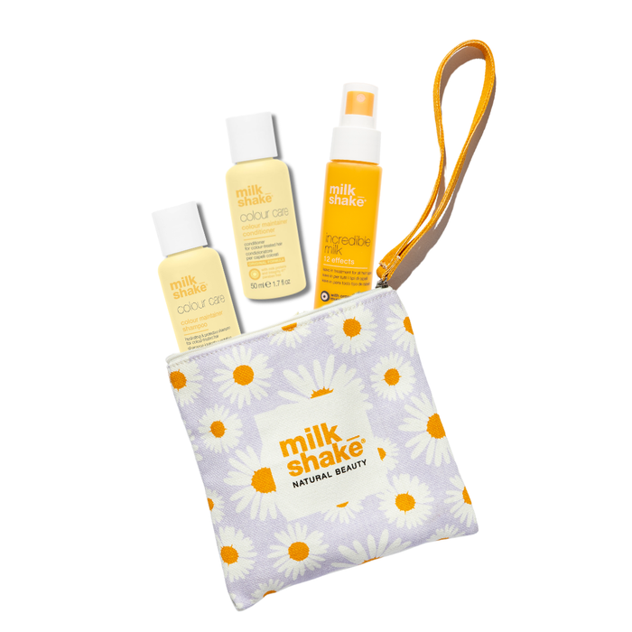 Set of 'milk shake' beauty products including bottles and a pouch on a white background