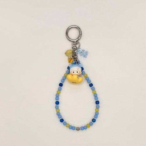 Keychain with beads and a small figure toy on a light gray background