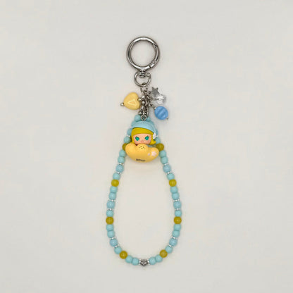 Beaded keychain with character charm on a light gray background