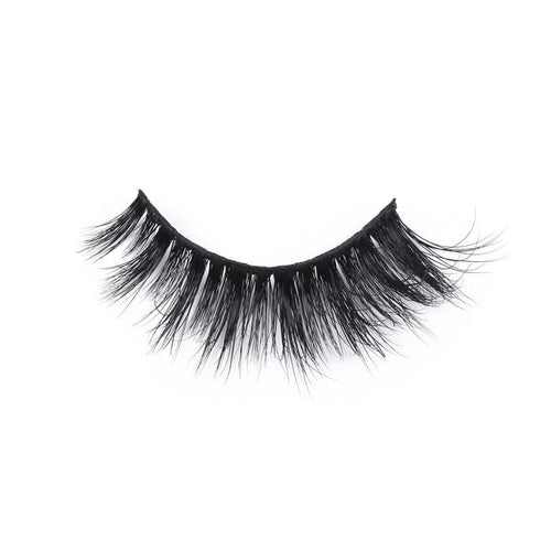 A single false eyelash strip with thick, long, wispy black lashes, slightly curved for a dramatic look against a white background.