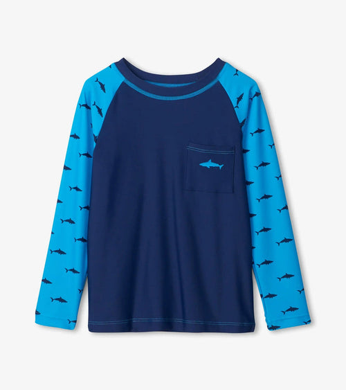 Front flat lay of Silhouette Sharks boys long sleeve rashguard with shark print sleeves and pocket