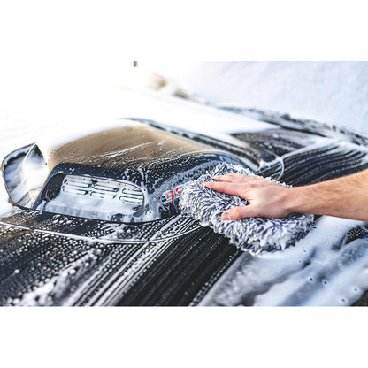 Black and White wash pad being used to wipe down a black car hood