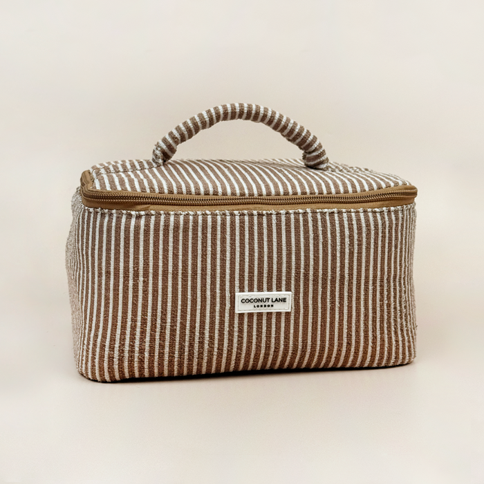 Vanity case with chestnut brown and white stripes, handle, and zipper; Coconut Lane branding visible.