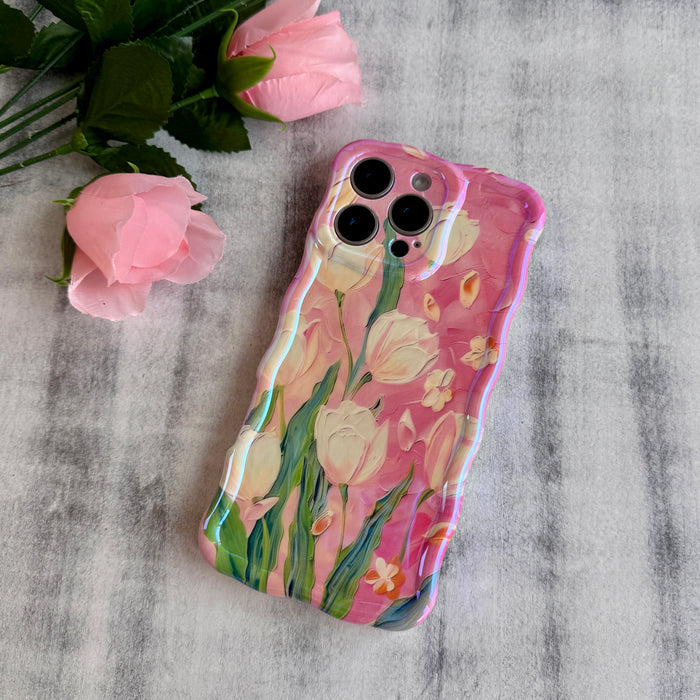 Pink wavy iPhone case featuring painterly white and pink tulips with green stems and iridescent finish.